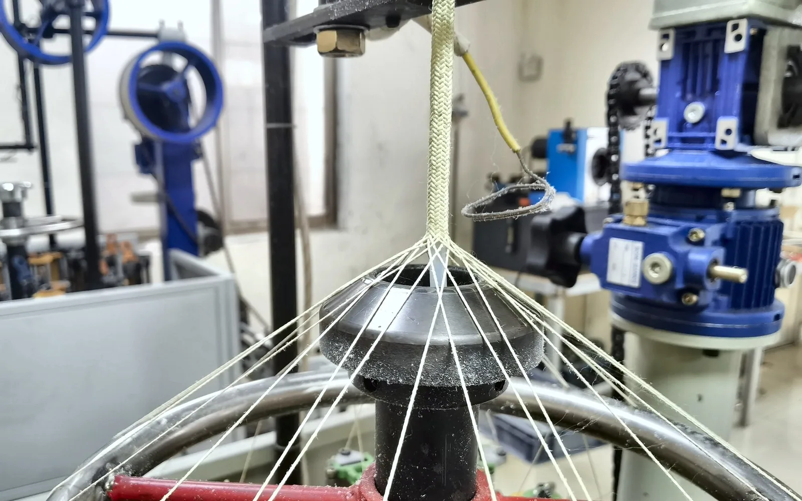 Reinforcing braid being applied around a motorcycle line